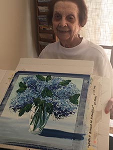 resident shows her finished painting